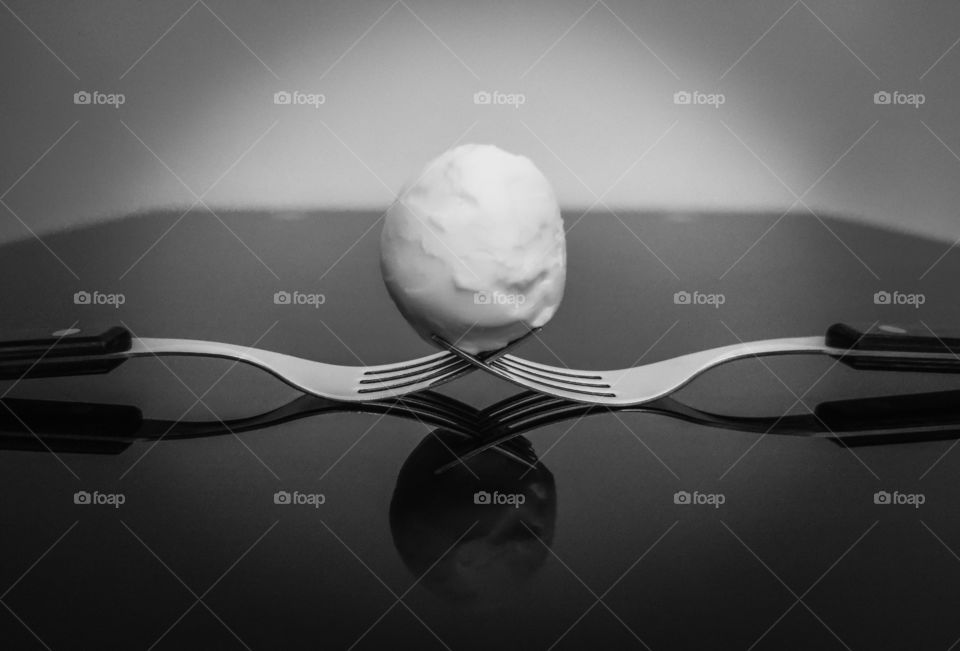 Forks and egg in reflection