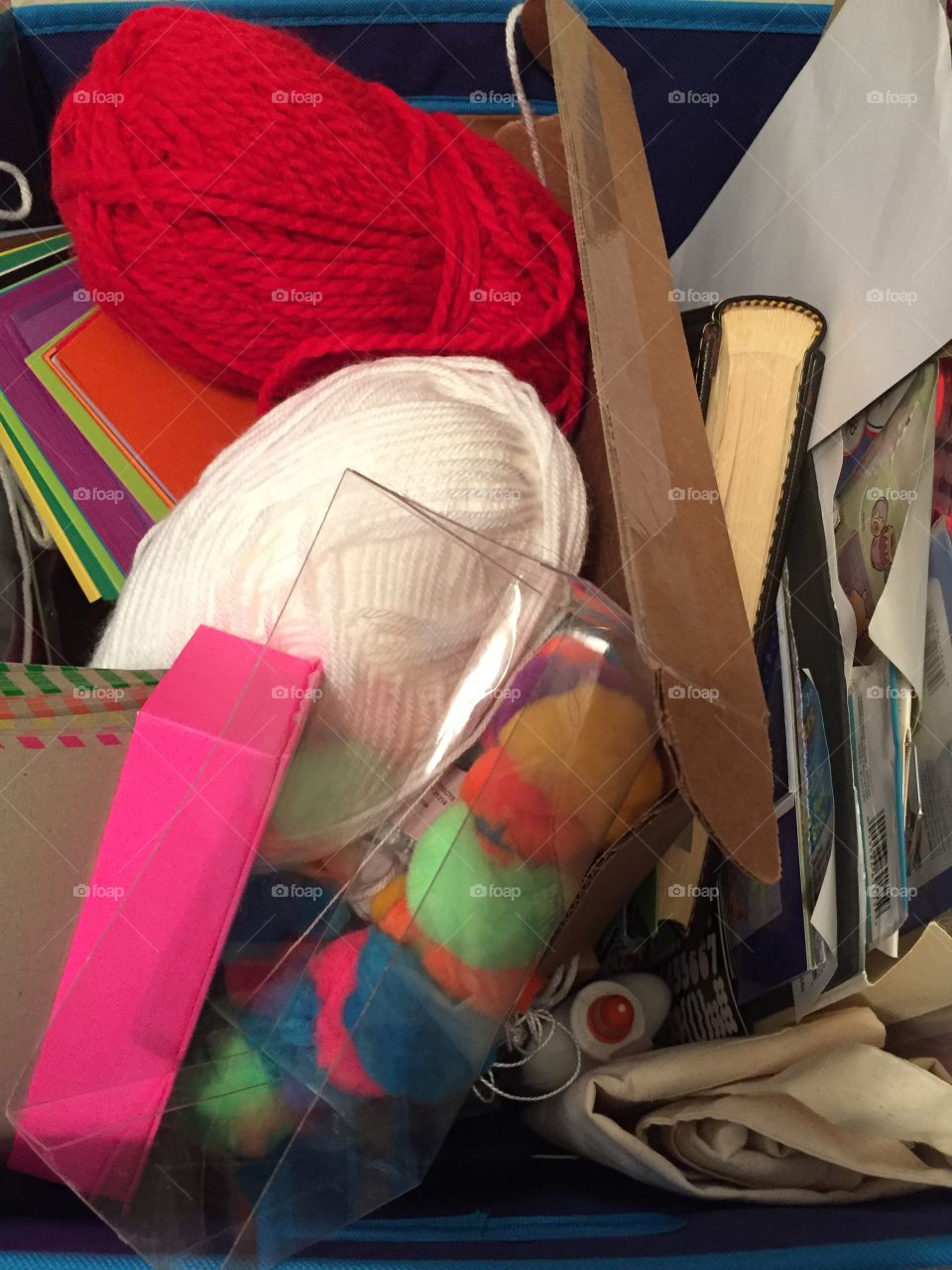 Messy box of arts and craft supplies 