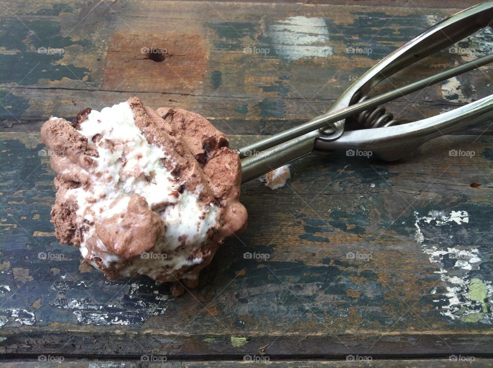 Close up view of ice cream. Creamy Italian chocolate and vanilla ice cream on a Old wooden table