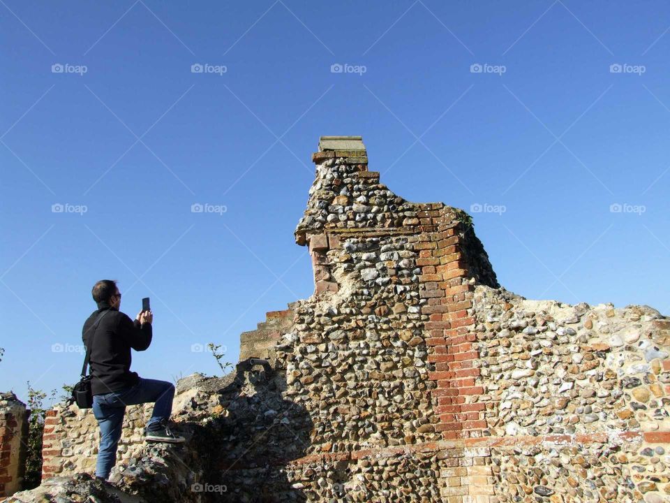 Man taking a photo of castle ruin