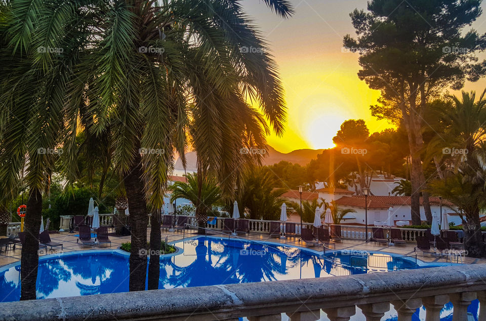 sunset over hotelpool in majorca, spain