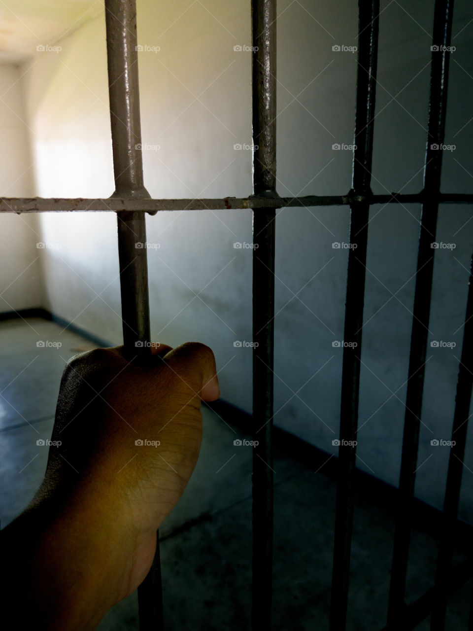 Asian hand put on prison cell