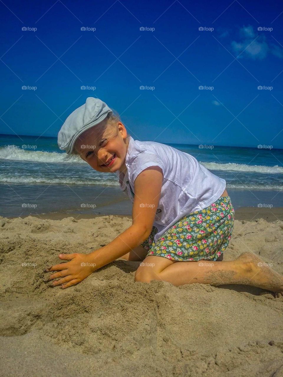 Lili building sand castle during summer time in Poland