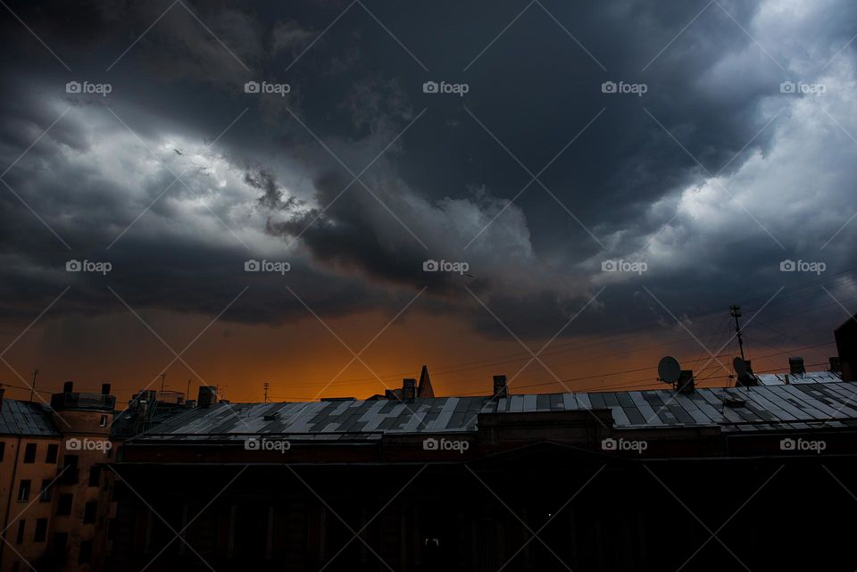 Dramatic sky over city roofs