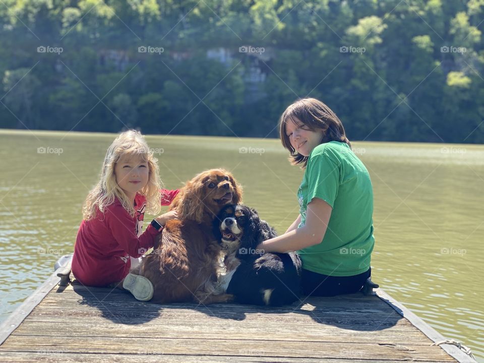 Two cute kids and their two cute dogs