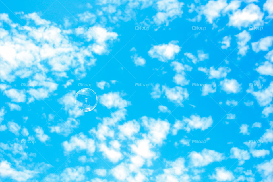 soap bubbles, blue sky, clouds.
