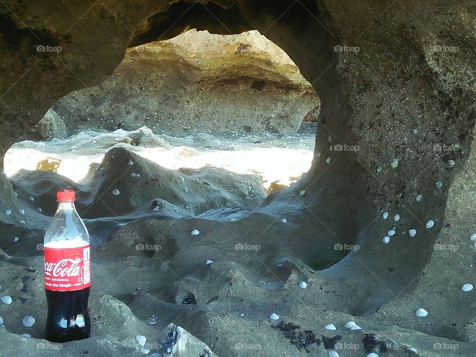 Sweety cocacola towards the cave near the beach at essaouira in Morocco.