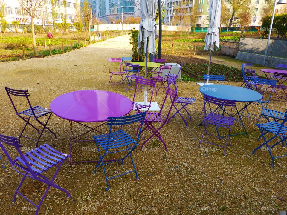 Nice and colorful tables and chairs in the garden,Milan.Italy