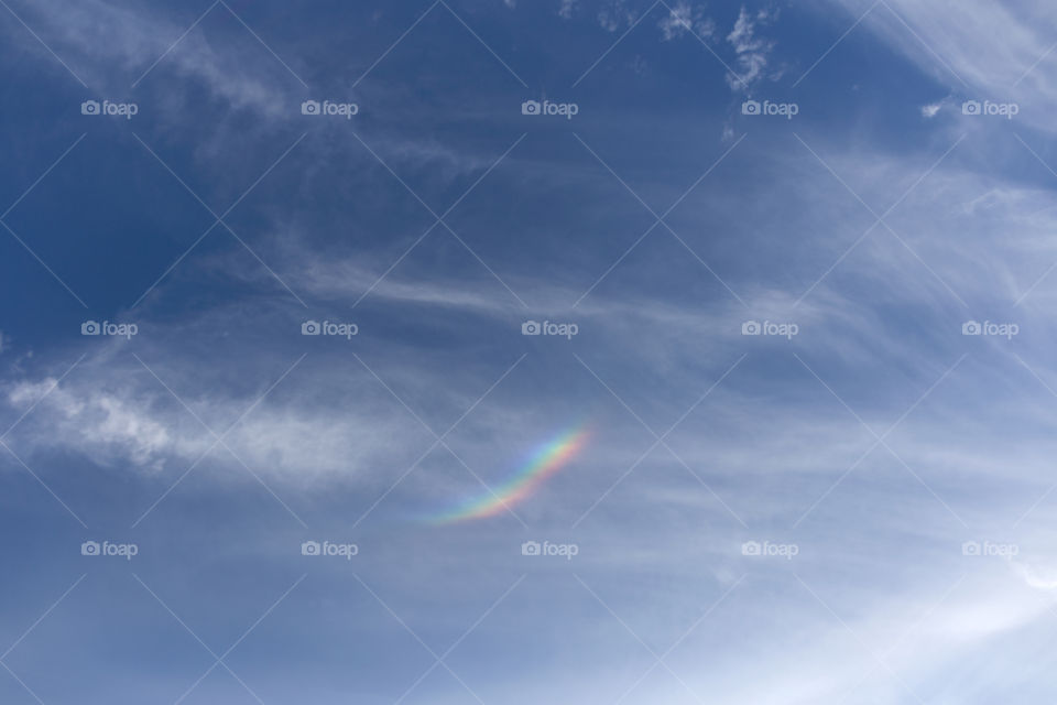 small rainbow in the cloud after rain