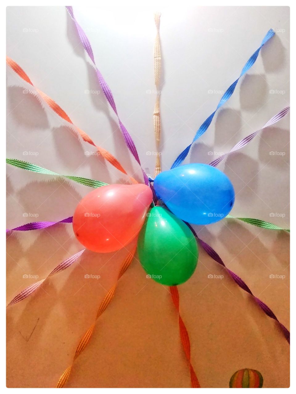 it is a very sweet illuminated baloon multi coloured ribbon sewing item Celebration white background birthday holiday event close up in Patna India