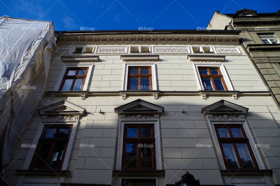 Low angle view of building exterior against clear sky in Kraków, Poland.