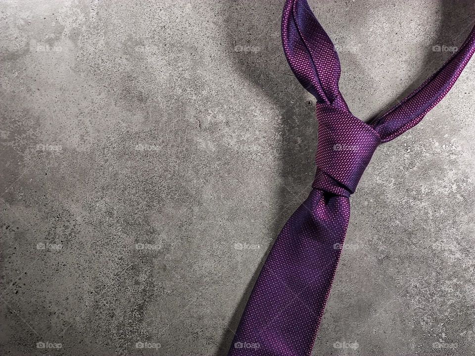 purple tie on gray background