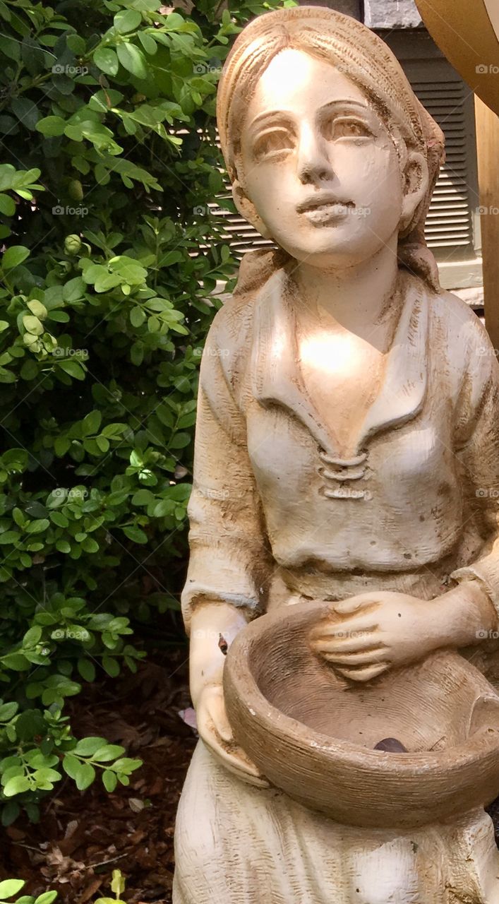 Girl statue greenery