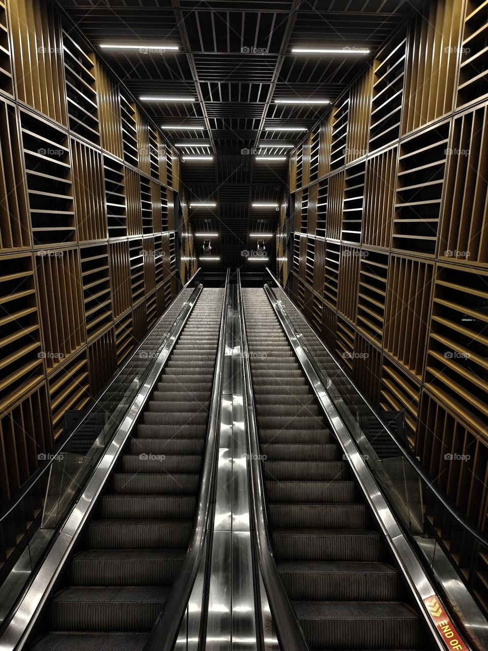 view of escalator surrounded with rectangular shaped blocks