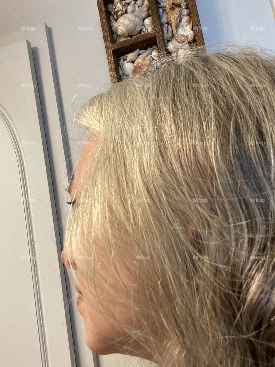 A profile view of my once-dark hair, which I recently stopped coloring. I’m curious to see what color it will end up after so much coloring and touching up. The layer underneath is darker than the top, so it looks almost frosted.