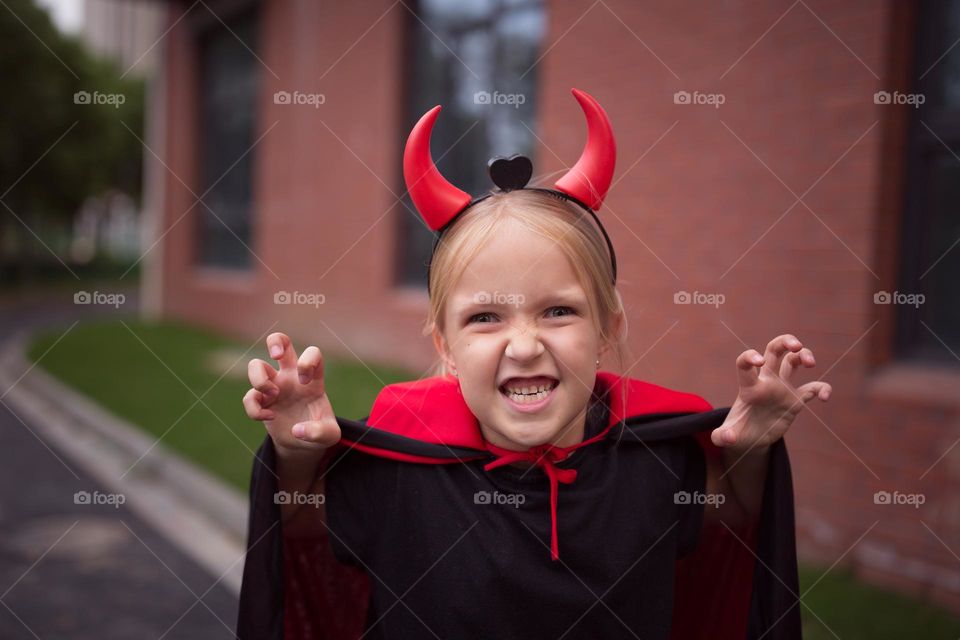 Happy kid celebrating Halloween outdoor 