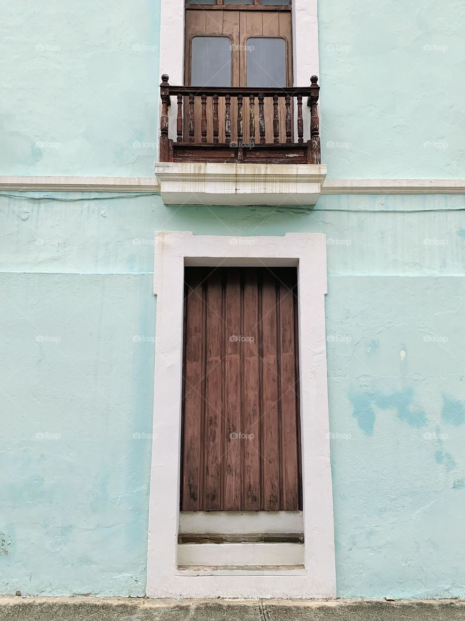 The brown door and the light green wall