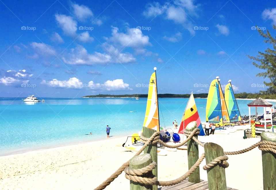 Beautiful colorful sailboats on a Crystal clear water ocean beach front