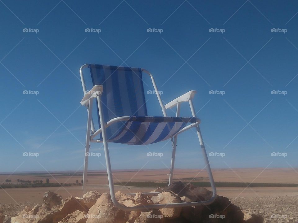 A chair on rocks