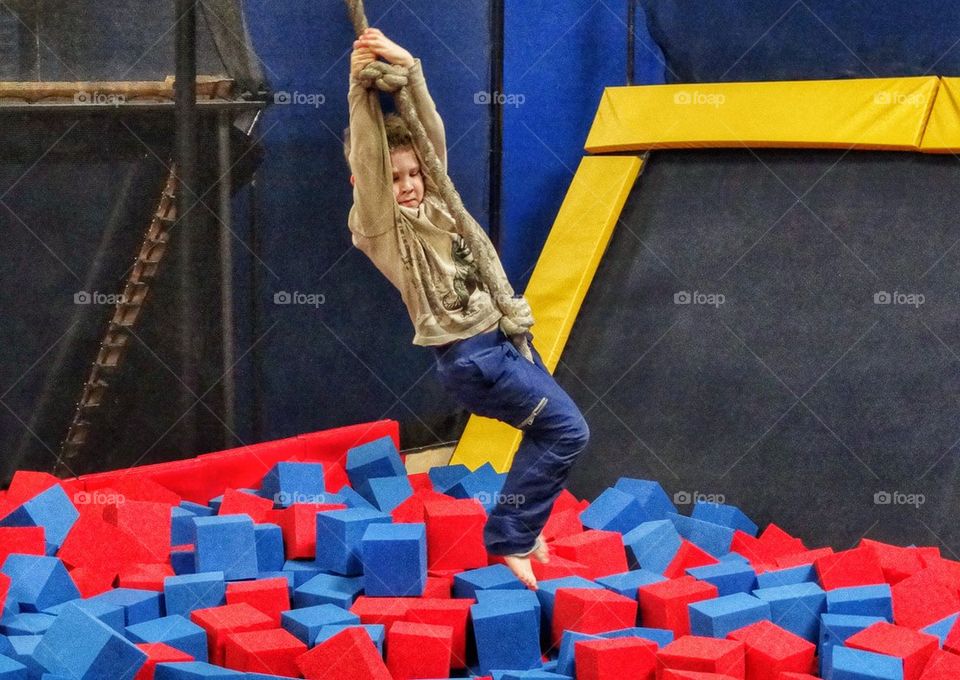 Little Boy Swinging On A Rope. Confidence Building Activity