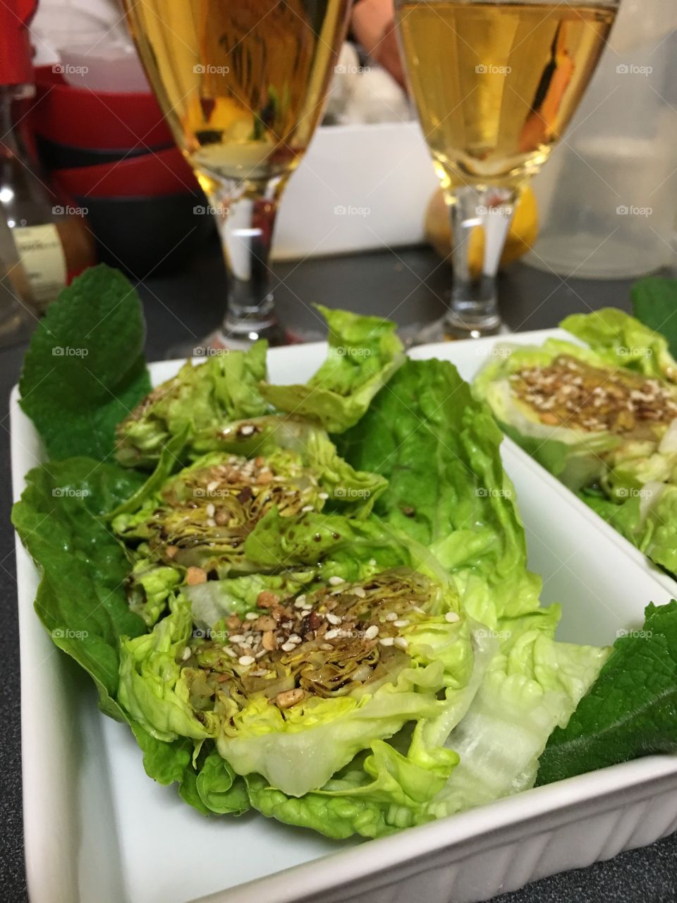 Healthy and fresh baby berg lettuce rounds salad side dish with balsamic dressing and topped with dukkah 