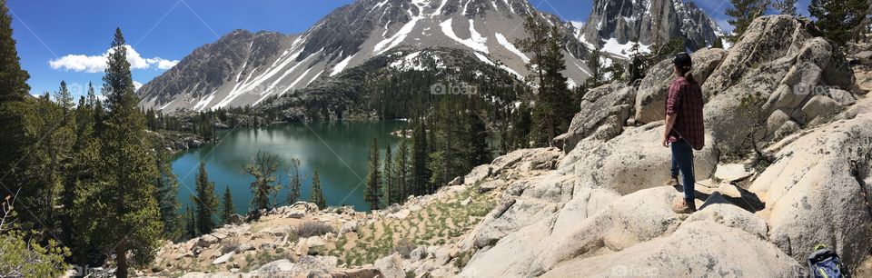 Overlooking a turquoise alpine lake in the Sierra Nevada’s.