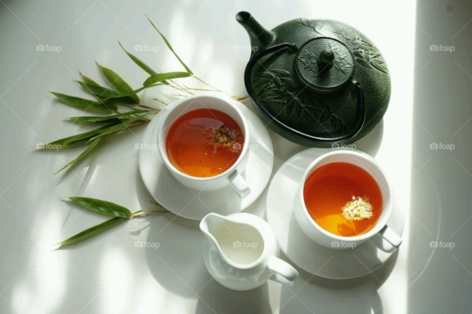 High angle view of tea cup and tea pot