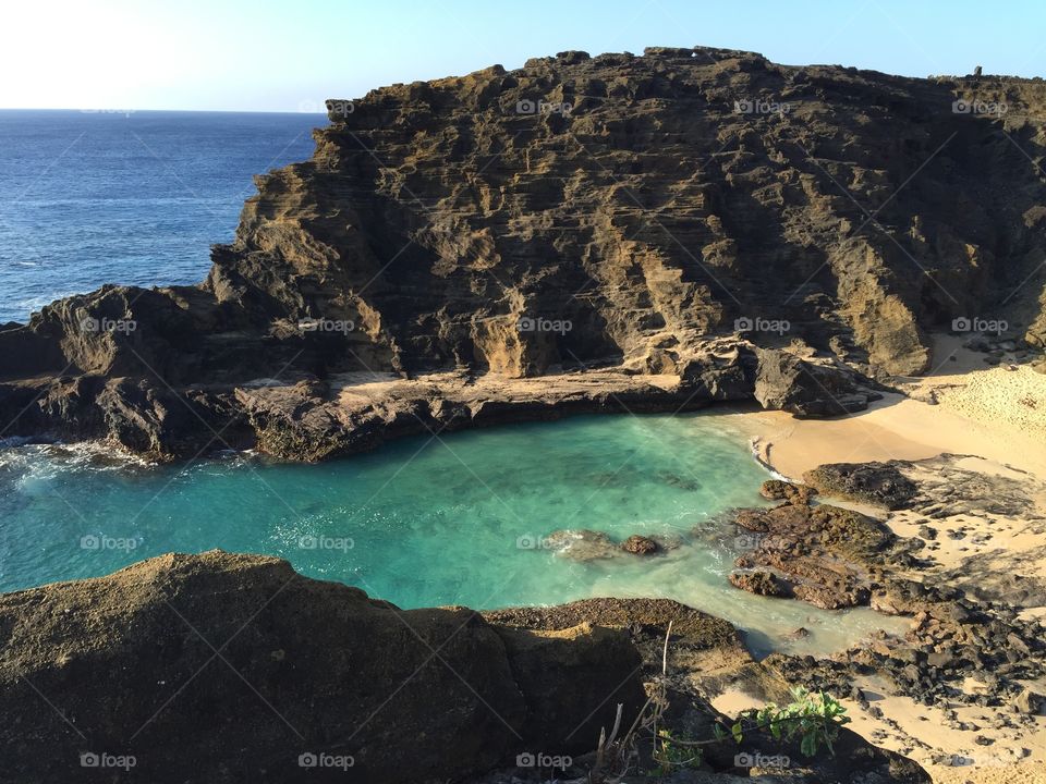 Overlook of the crystal clear waters of Cockroach Cove on the south shore of Oahu, Hawaii.