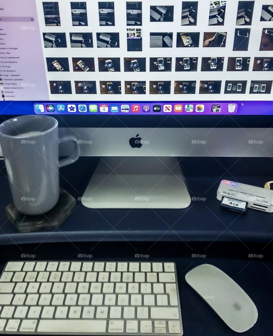 Photo editor’s desk, with large cup of coffee