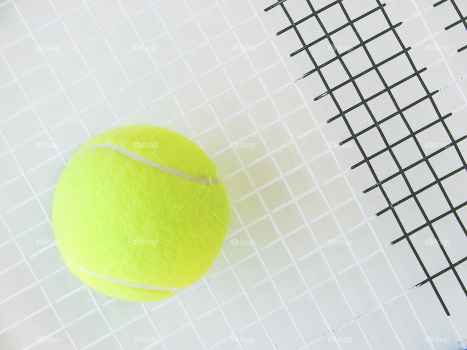 Tennis ball on racquet