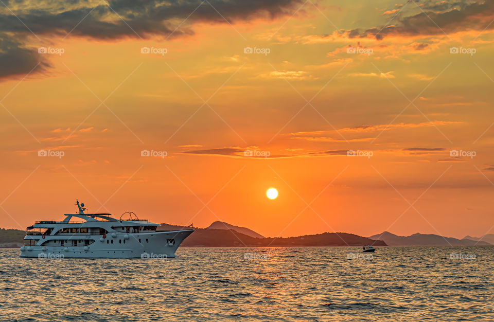 Ship sails at sunset