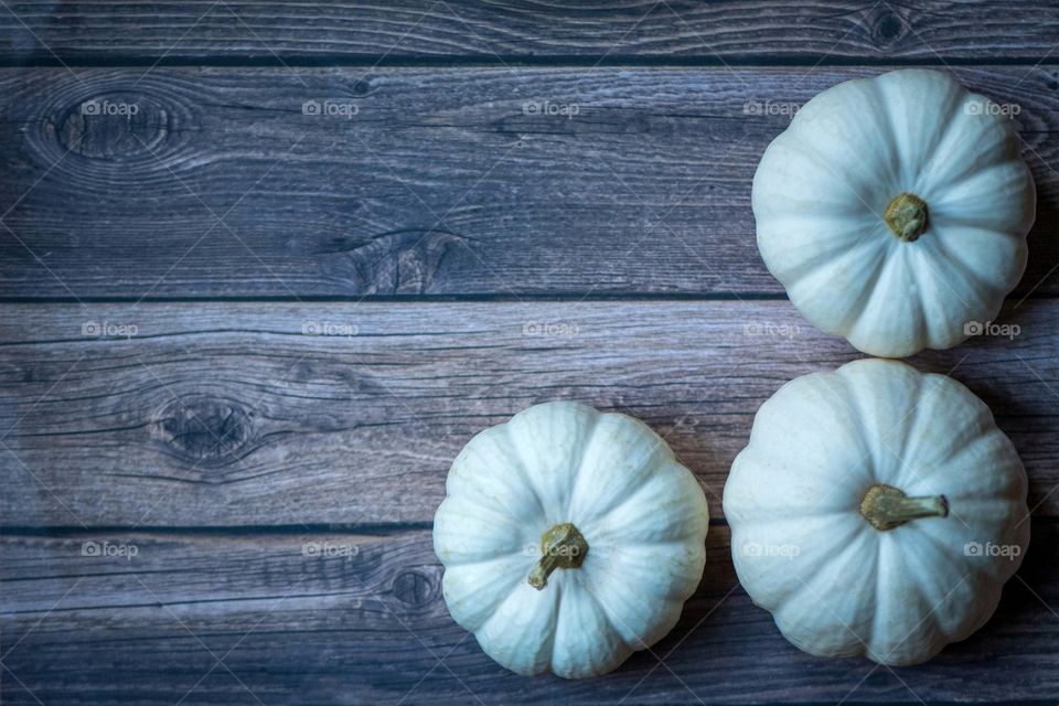 White pumpkins on a wooden board