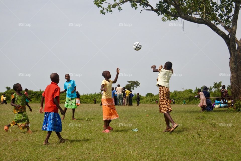 Play ball. African school girls playing soccer 