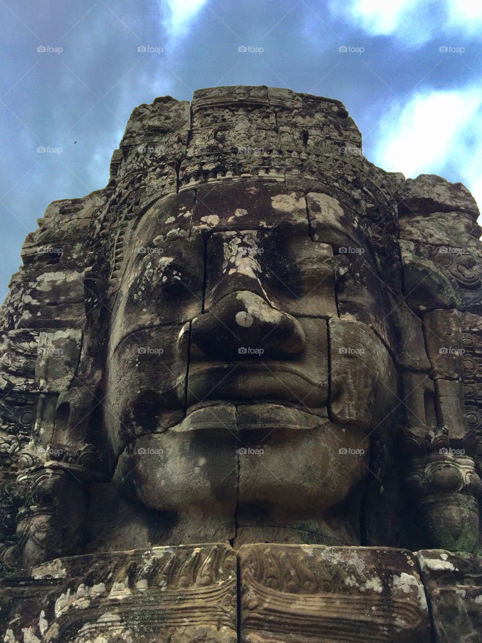 Face in a stone at the Bayon Temple in Angkor Archaeological Site 