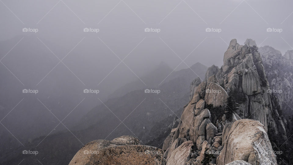 The hight rock Ulsanbawi in snow storm. Seoraksan National Park. South Korea 
