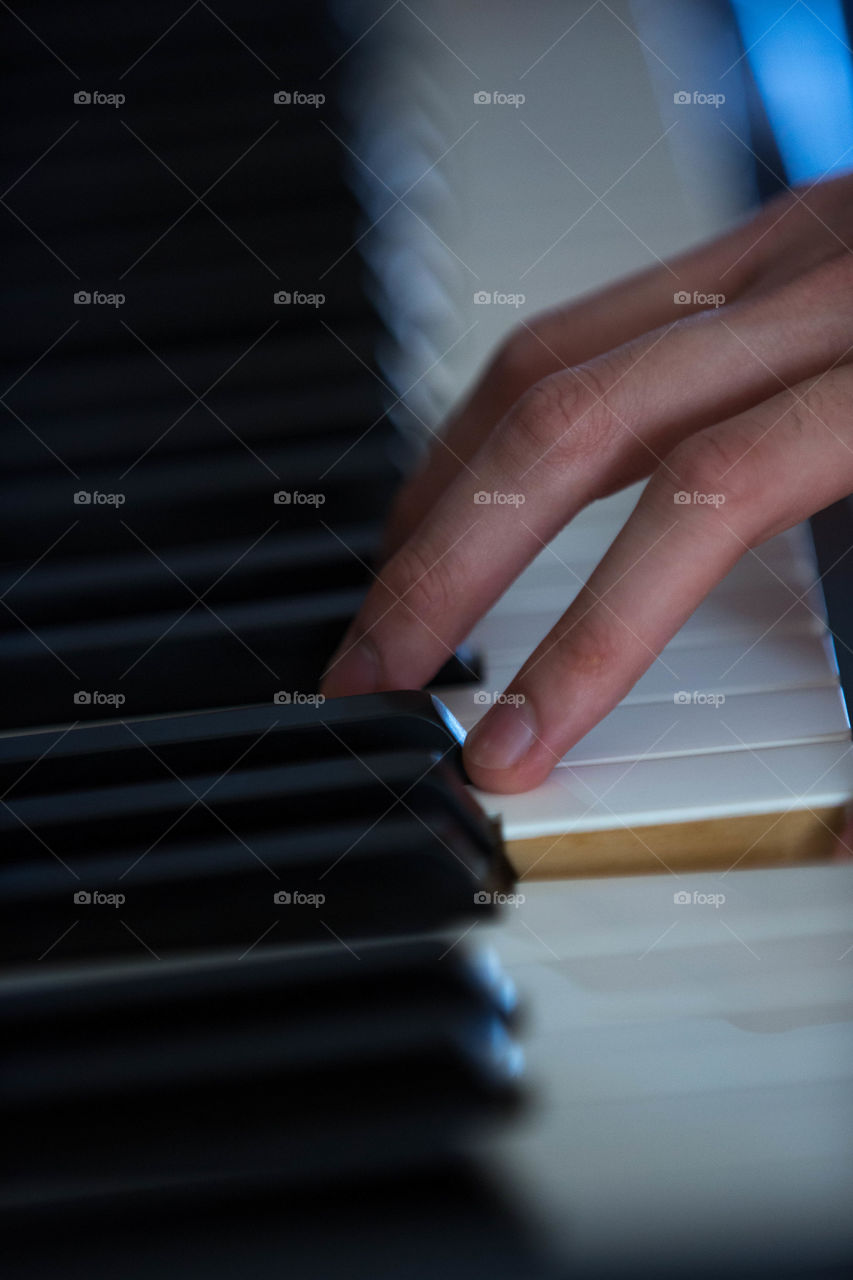 Skilled hands working on a piano, delicate