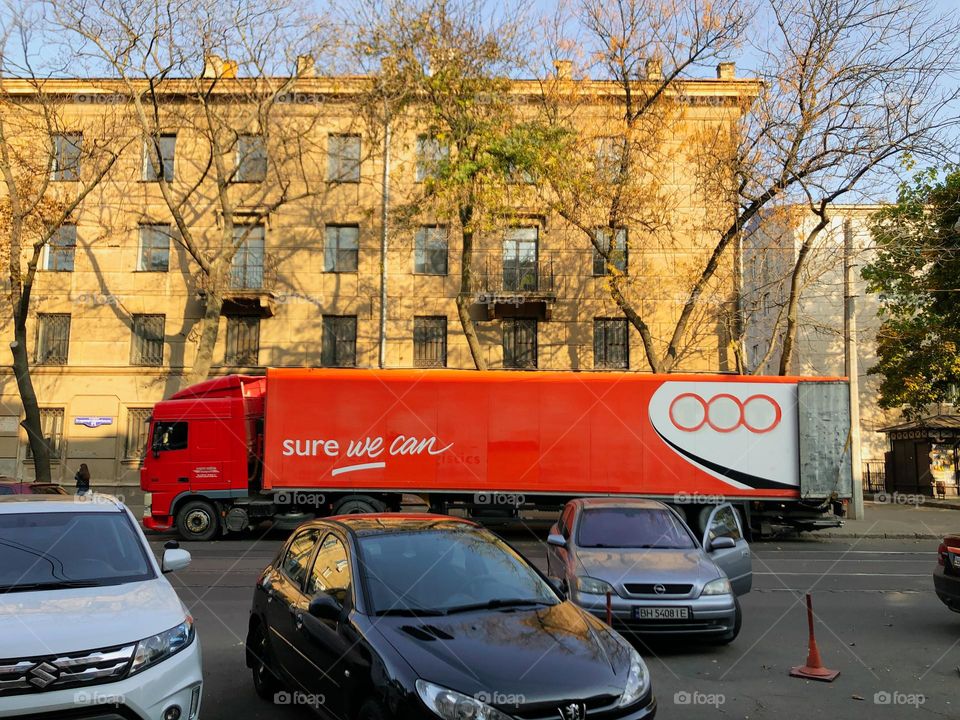 rectangular red machine on the street 