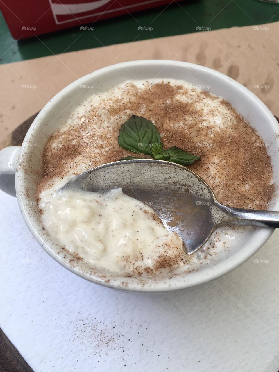 Rice with milk dusted with cinnamon powder and decorated with mint leaves, rice pudding, milk with rice, arroz con leche 