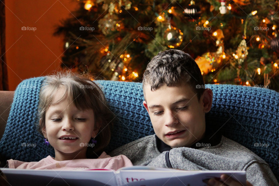 Siblings reading a Christmas story