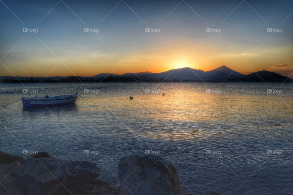 Boat in the sea at sunset