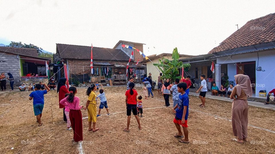 Potrait of a group of children were playing in the middle of the field in the afternoon