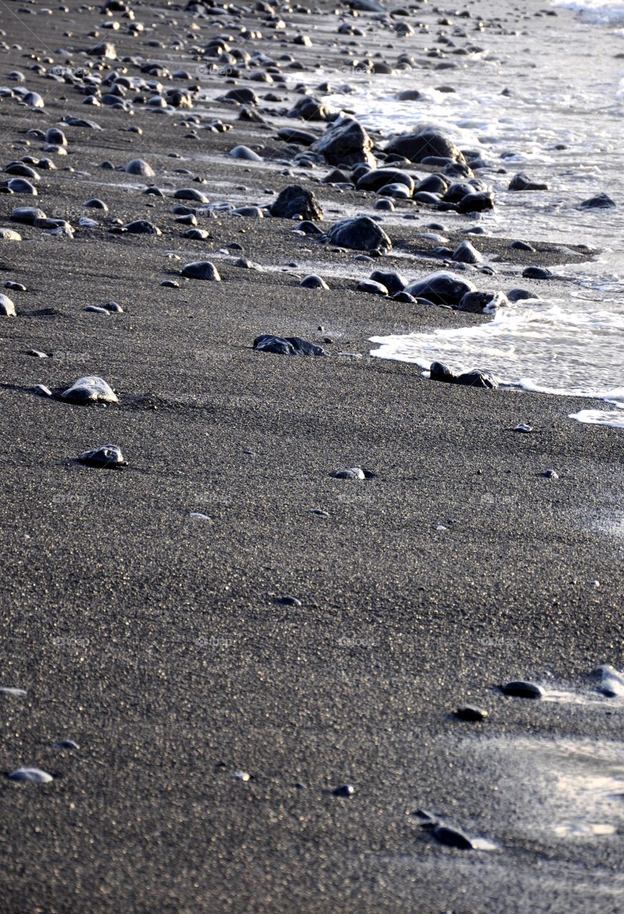 Stones and black sand at beach