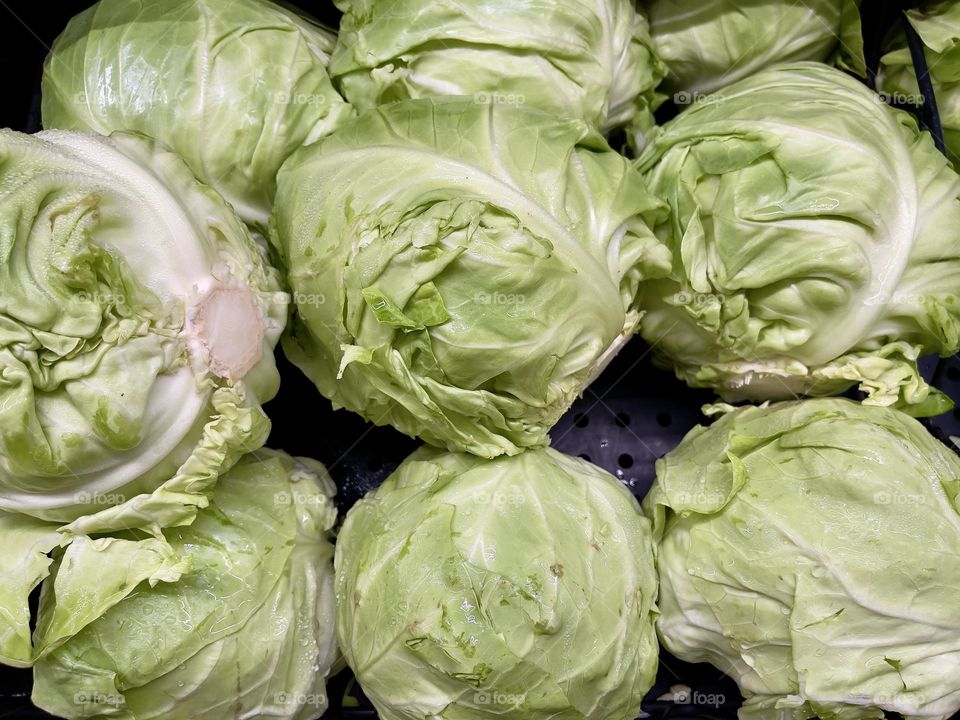 Green cabbage on the market shelf, top view 