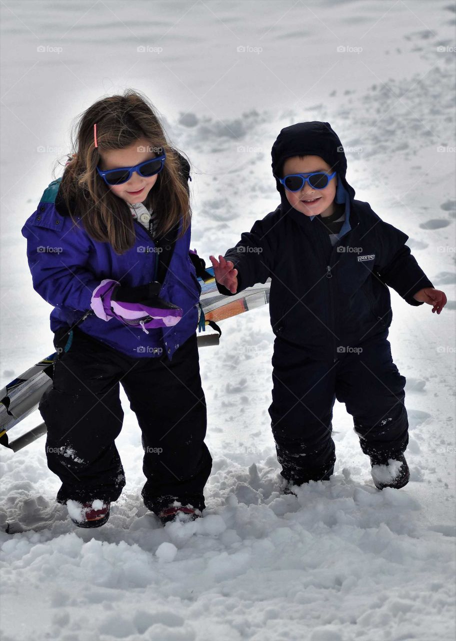 siblings sledding