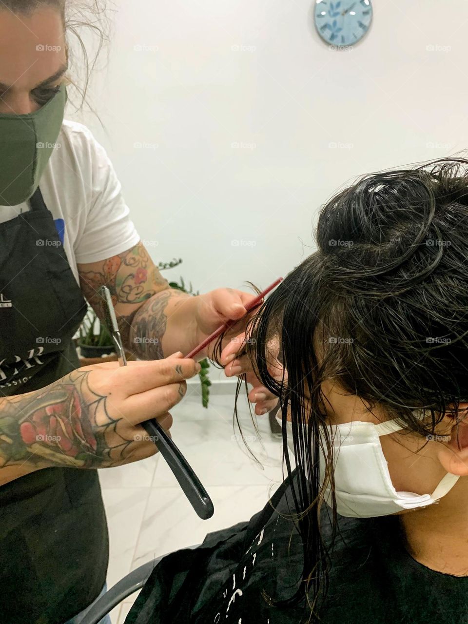 hairdresser cutting girl's hair