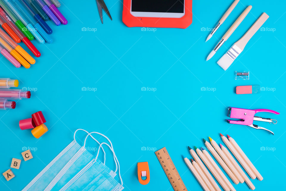 Set of school items on blue background. Back to school concept. Top view. Copy space