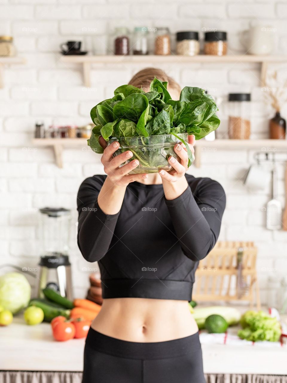 woman holding spinach