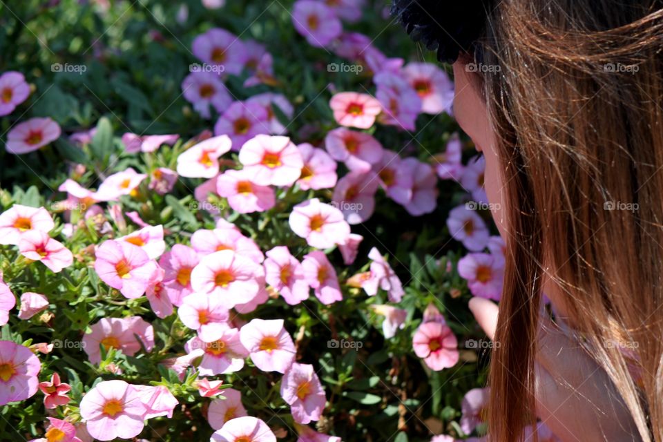 Girl Smelling the Petunias