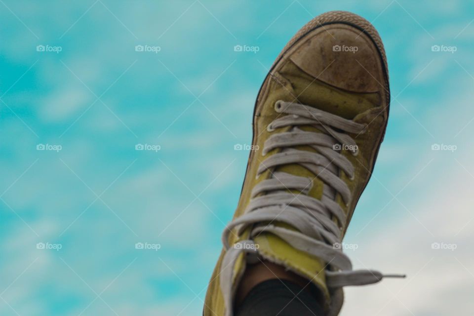 "Green shoe with a beautiful sky"