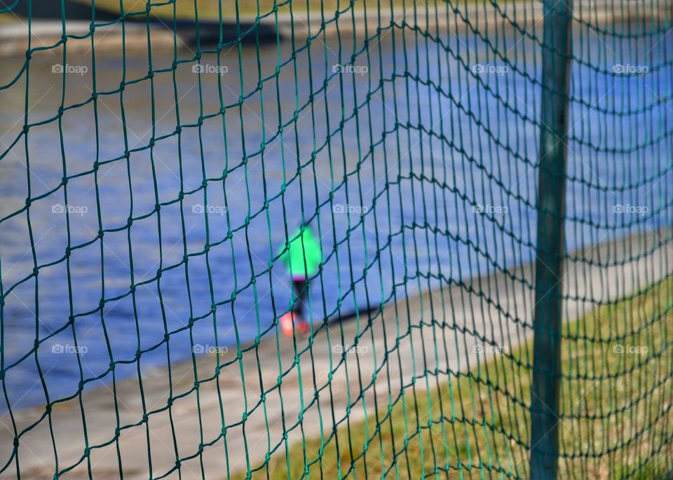 Green net and green blurred runner